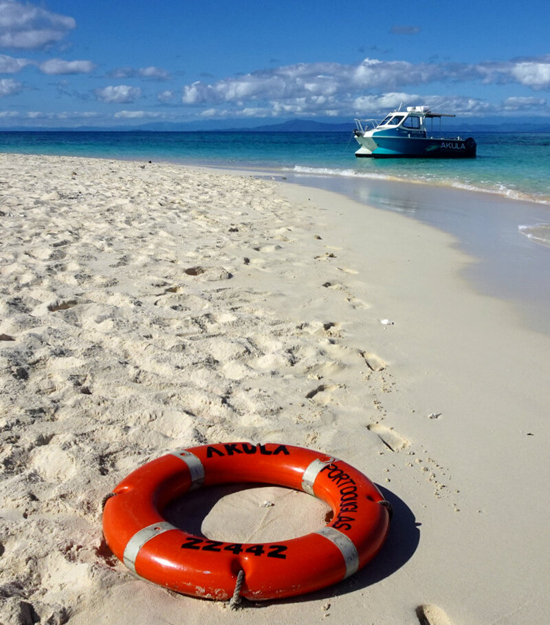 A life buoy on a sandy beach
