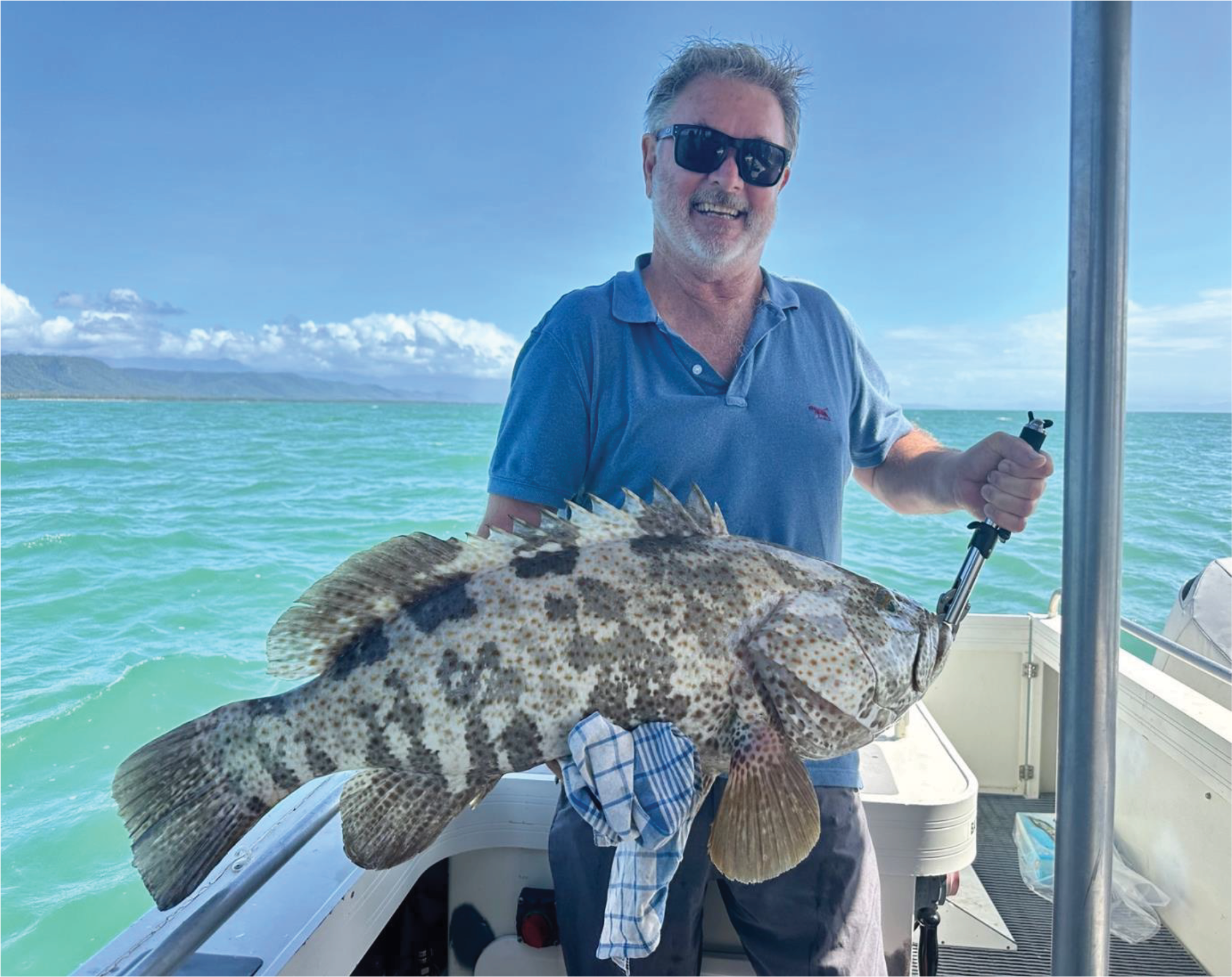 Angler holding a freshly caught grouper